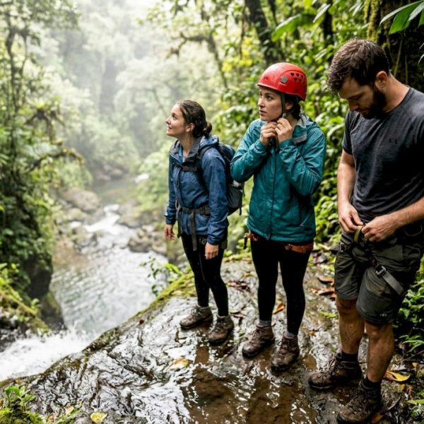 Adventure travelers gearing up at Jacó waterfall