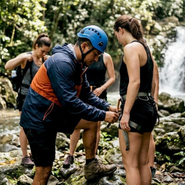 Guide checks harness near Costa Rica waterfall