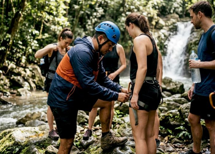 Guide checks harness near Costa Rica waterfall