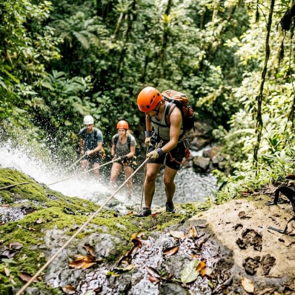 Adventurers rappelling down Costa Rica waterfall