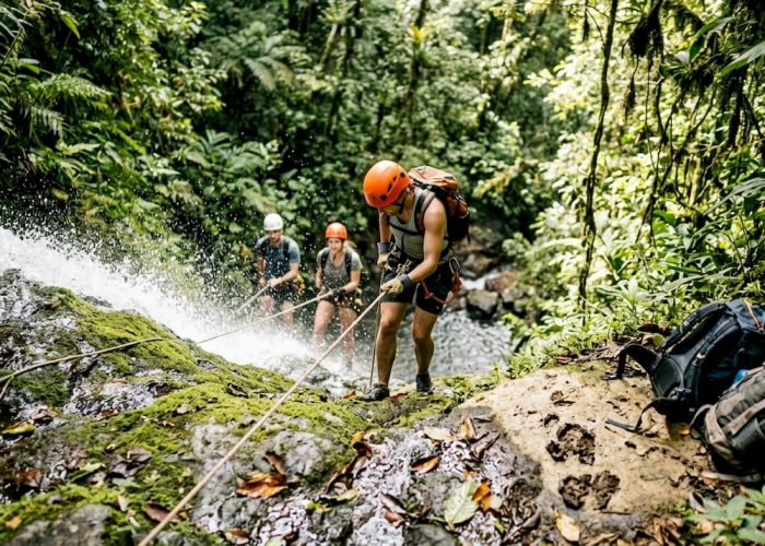Adventurers rappelling down Costa Rica waterfall