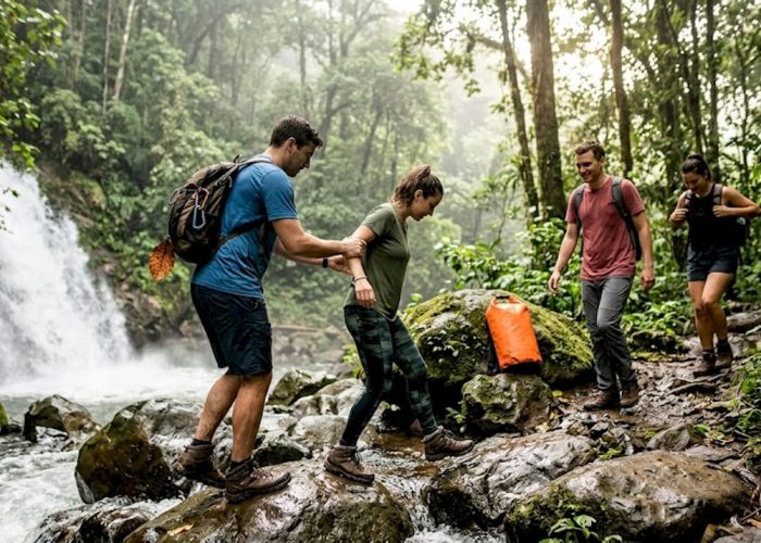 Group hiking by Costa Rica waterfall trail